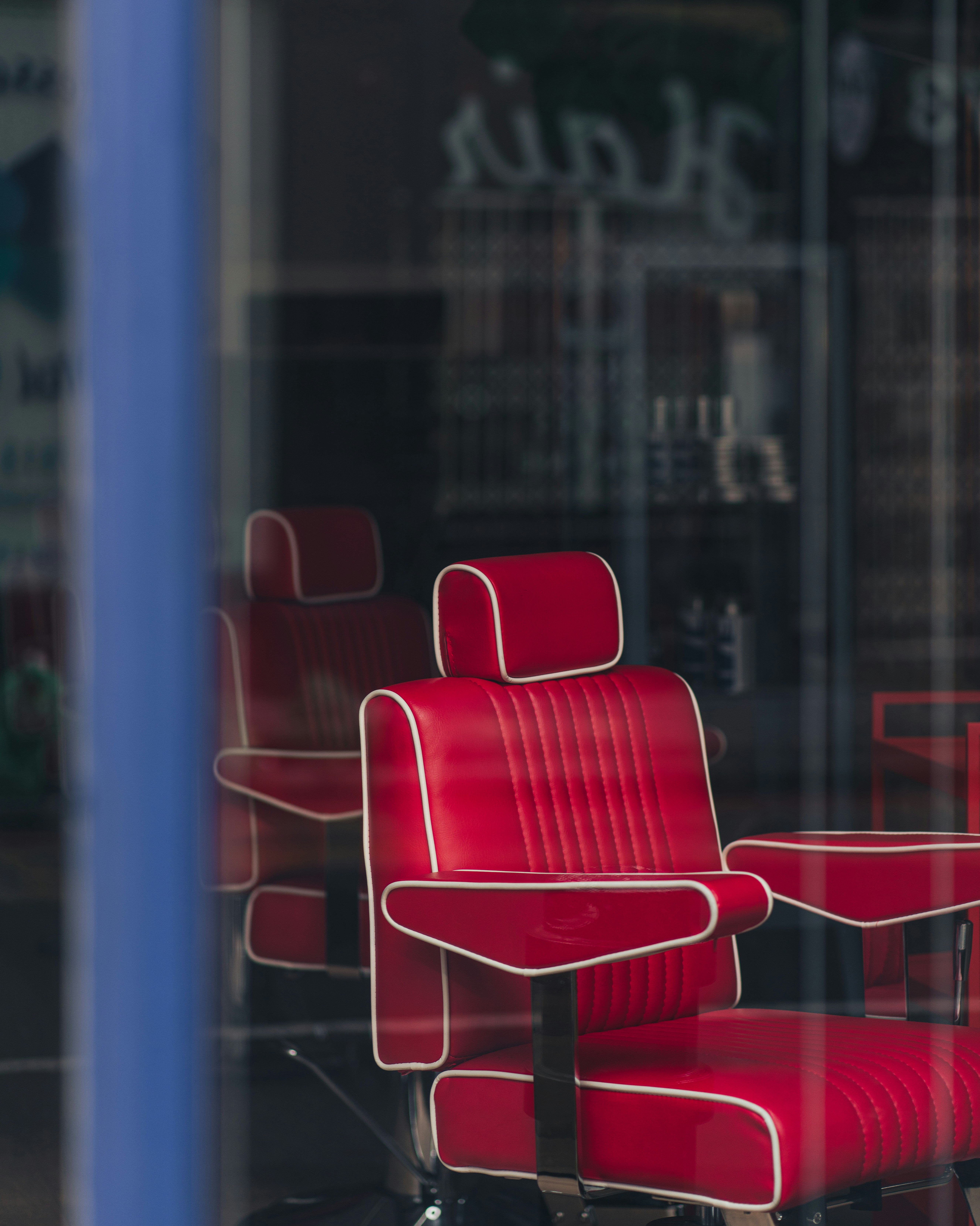 red and white chair near glass window